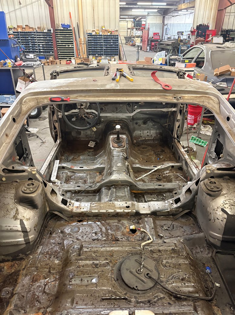 Completely stripped interior of the 1984 Nissan 300ZX, bare metal floorpan and transmission tunnel