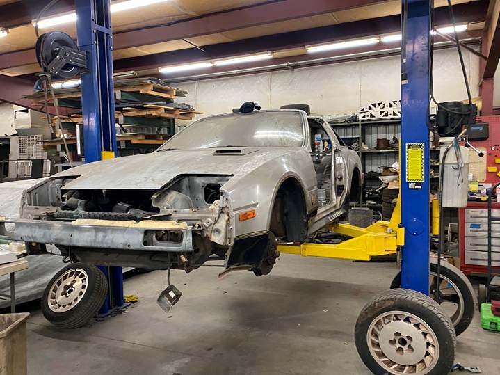 Front three-quarter view of the 1984 Nissan 300ZX during teardown, front end being dismantled