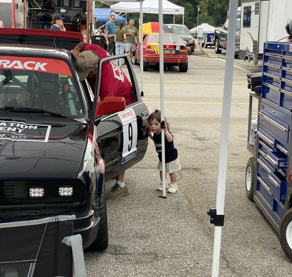Our youngest team member by the E30 in the paddock